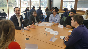 Jordan Buck sat at a table talking to students at the beyond the Classroom event.