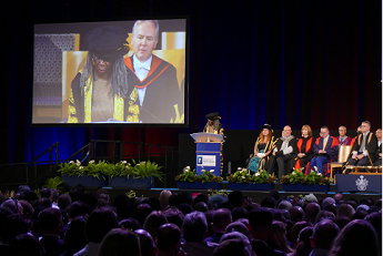 Graduation summer 2024. Chancellor Baroness Lola Young of Hornsey OBE on stage giving speech to audience