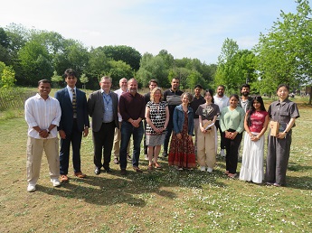 Student members of the Sustainability and Societal Impact (SSI) Fellows Programme 2024 and Nottingham University Business School staff standing in a group on grass with trees behind on The Jubilee CampusStudent members of the Sustainability and Societal I