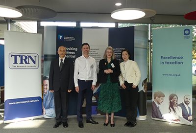 Dr Hafez Abdo, Chris Irwin (HMRC), Professor Jane Frecknall-Hughes, Dr Jinning Hong standing in front of Nottingham University Business School and Tax Research Network (TRN) banners.