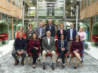 Photo of the Business School Senior Leadership Team including, from left to right front row: Andrew Smith, Sara Turner, David Park (Dean), Hang Le and Jillian Rickly. From left to right, back row: Anne Touboulic, Janet Cook, Andrew Bacon, Paul Bartlam, Ja
