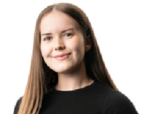 Megan Bates, smiling with long mid brown hair and wearing a black top