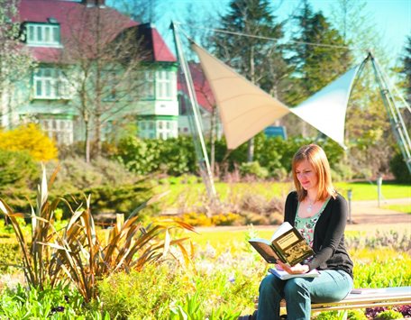 Female postgraduate studying millenium garden