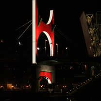 A structurally interesting red bridge shot at night and lit to highlight curves and hard lines