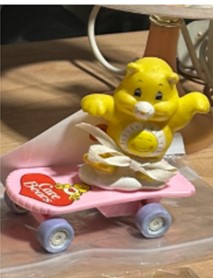 Funshine Bear figurine on a skateboard