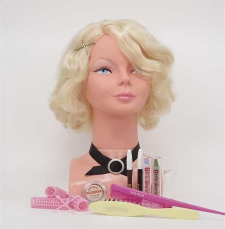 The accessories in the Girl's World box laid out in front of a makeup and hairstyling model