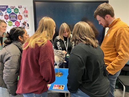 MJMS Placement students inspecting a selection of objects from Leicestershire Museum Collections.