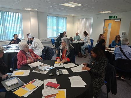 Attendees exchanging ideas during workshop group discussion.