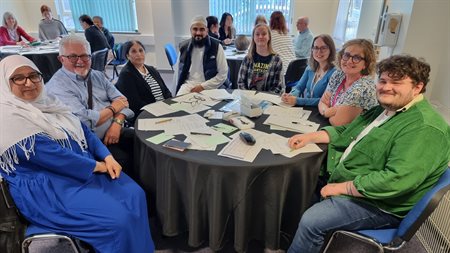 Attendees posing for a photograph during workshop group discussion.