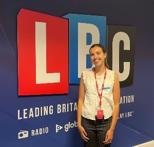 Francesca Montefusco standing in front of an LBC wall graphic