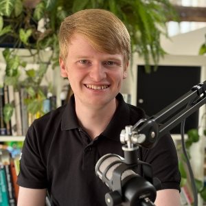 Joshua Wright sitting in front of a radio mic