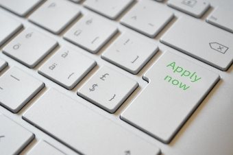 Part of a keyboard with one key labelled Apply now