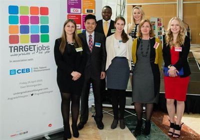 Group of people next to a Undergraduate of the Year advertisement