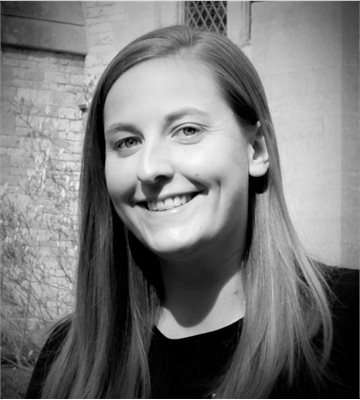Black and white headshot of Rebecca Thumpston, smiling
