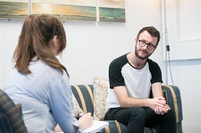 People sitting on the sofa and having a conversation