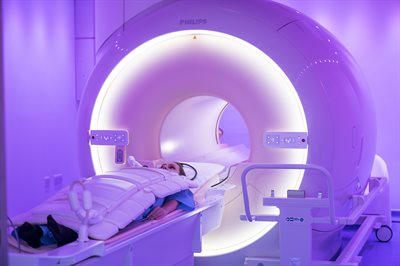 Patient having MRI scan.  The patient is lying on the MRI bed waiting to enter the MRI machine.