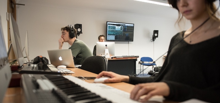 Students composing music on keyboards and computers