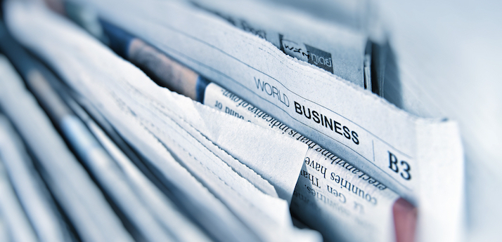 Newspapers close up displaying business headlines
