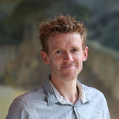 Chris Dodds stood looking at a camera