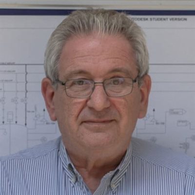 Seamus Higgings stood next in front of a whiteboard.