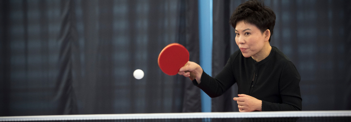 Deng Yaping playing table tennis 714x249