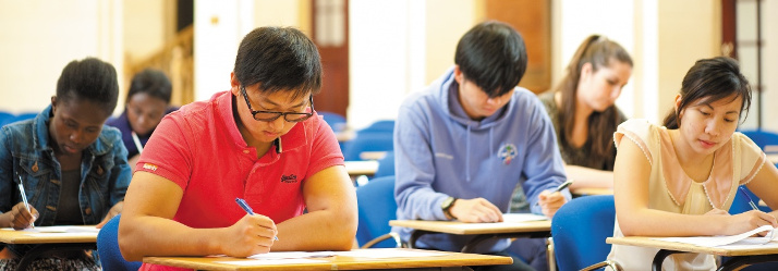 Undergraduate students sitting an exam in the Great Hall, University Park 714x249