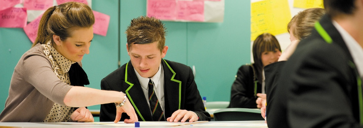 Female postgraduate student teaching pupils, Nottingham University Samworth Academy (NUSA) 2 714x249
