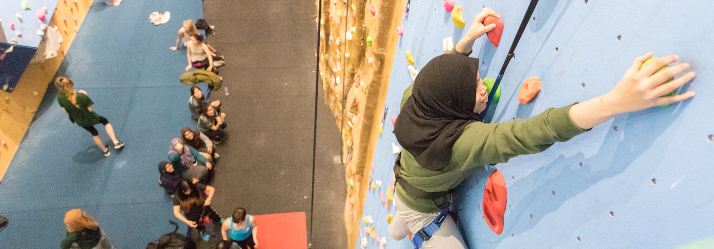 Female student using the DRSV climbing wall 714x249
