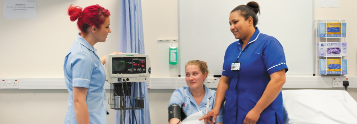 Female undergraduate student having her blood pressure checked, QMC 714x249