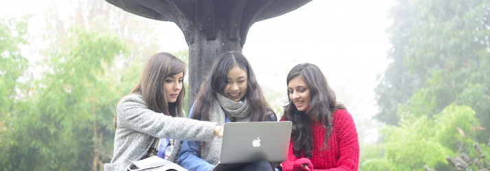 Female undergraduate students relaxing at Walled Garden, University of Nottingham 714x249