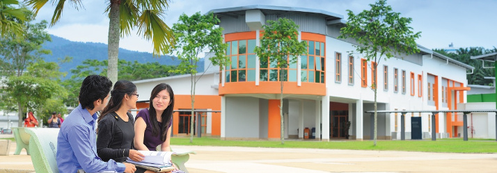 Male and female postgraduate students outside the business school, Malaysia Campus 2 714x249