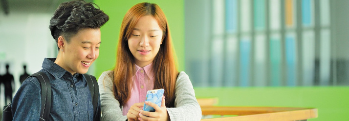 Pair of female undergraduate students relaxing at New Teaching building, Ningbo Campus, China 714x249