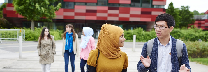 Postgraduate students walking around Innovation Park 714x249