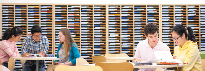 Students working in groups 714x249