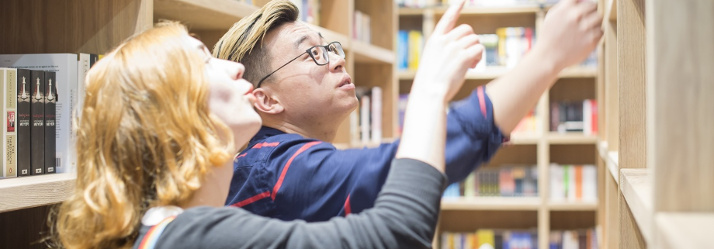 Students looking in the Bookshop situated in the Portland Building, Ningbo Campus 714x249