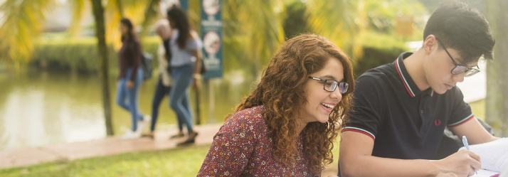 Students studying outside, Malaysia Campus 714x249