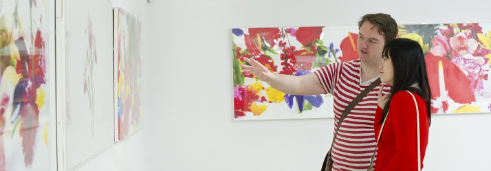 Two undergraduate students admiring artwork, Popart to Britart exhibition, Djanogly Art Gallery 714x249