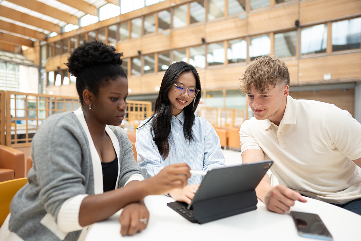 Students working around a laptop