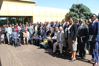 Group photo of male and female colleagues working on a HE project in Zimbabwe