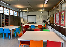 Photo of a science lab in the School of Education, tables, chairs, white board, displays on walls
