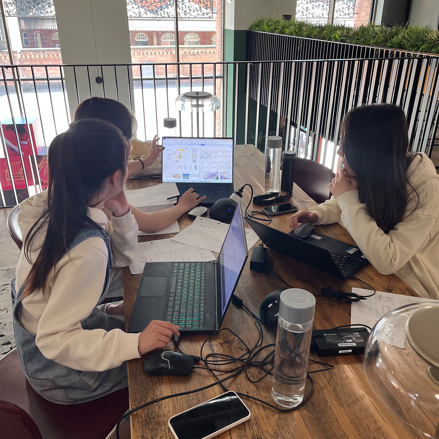 Yuhang Gu, Yanlin Wu and Jiali Yu studying around a table