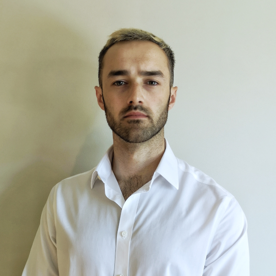 Head and shoulders portrait of Harry Nichols looking serious