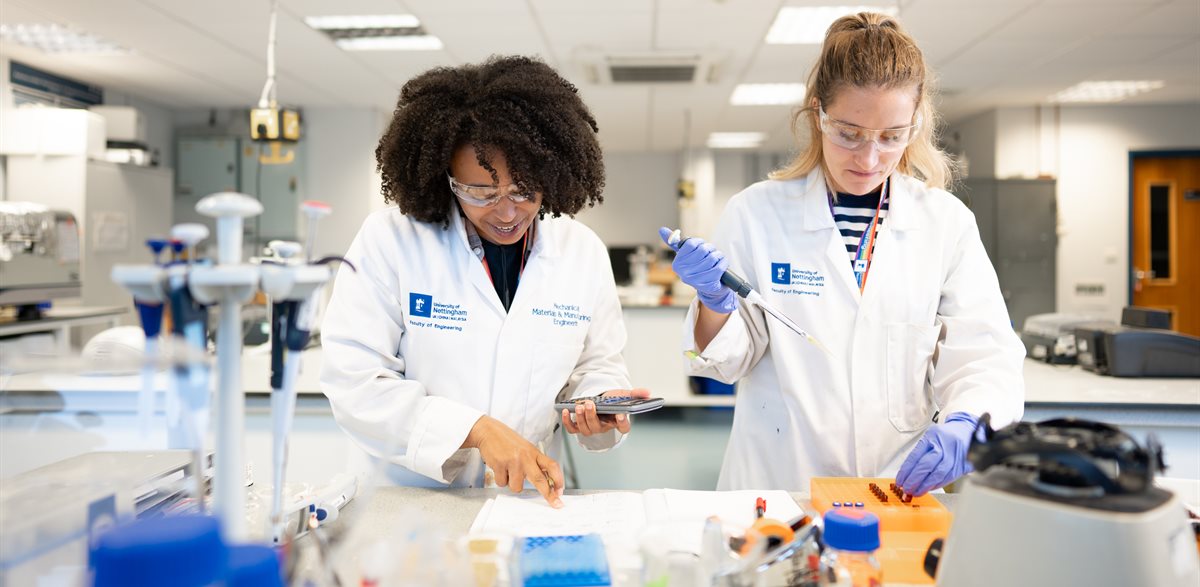 Two female PhD students working in the Food, Water and Waste laboratory