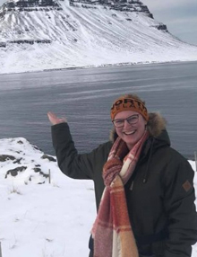 Cassidy Croci in Iceland, smiling in front of a frozen mountain