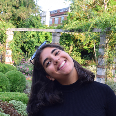 A headshot photo of Tereza Chanaki, a student from the School of English, in a garden