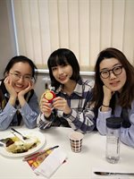 Three students sitting together at the Spring Festival event.