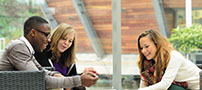 A group of students exchange notes in the Exchange Building, Jubilee Campus