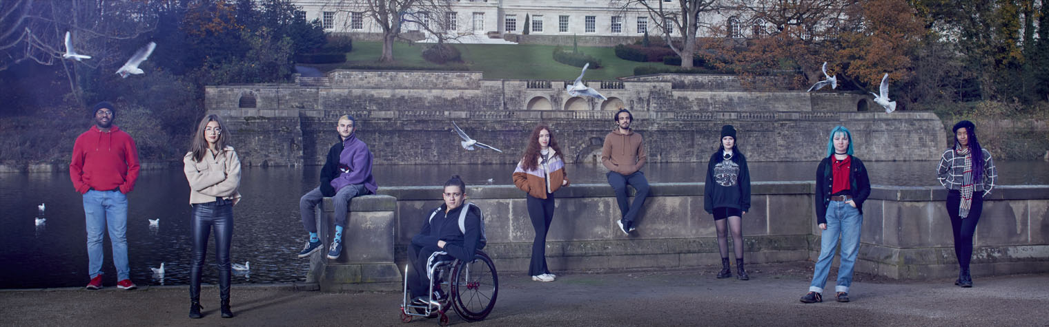 Students pose in front of a University building