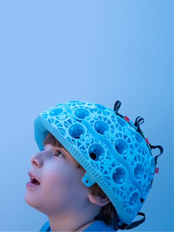 Child in blue research helmet with blue background