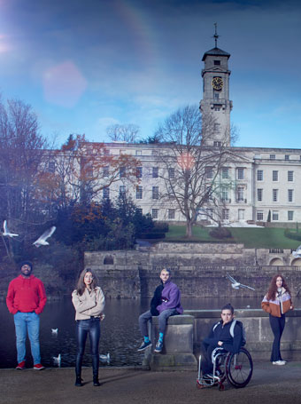 Students pose in front of a University building